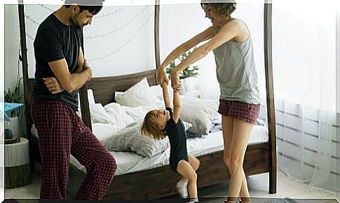 Parents dance with their child