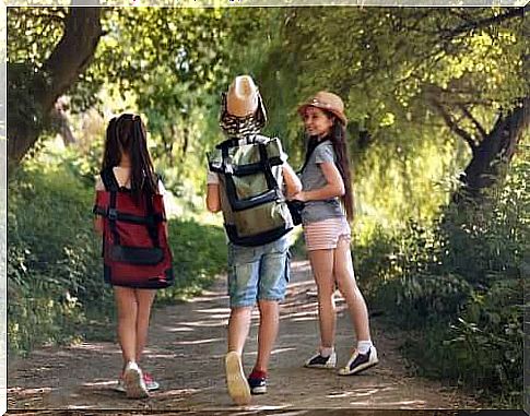 At the holiday camp: three girls are hiking