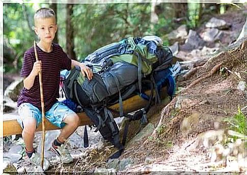 Child with backpack in summer camp