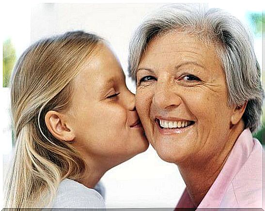 Grandchild kisses grandmother