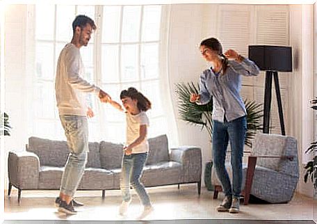 Keep moving: parents dance with their daughter