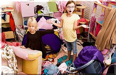 Full-time mother - Two children stand in a chaotic nursery